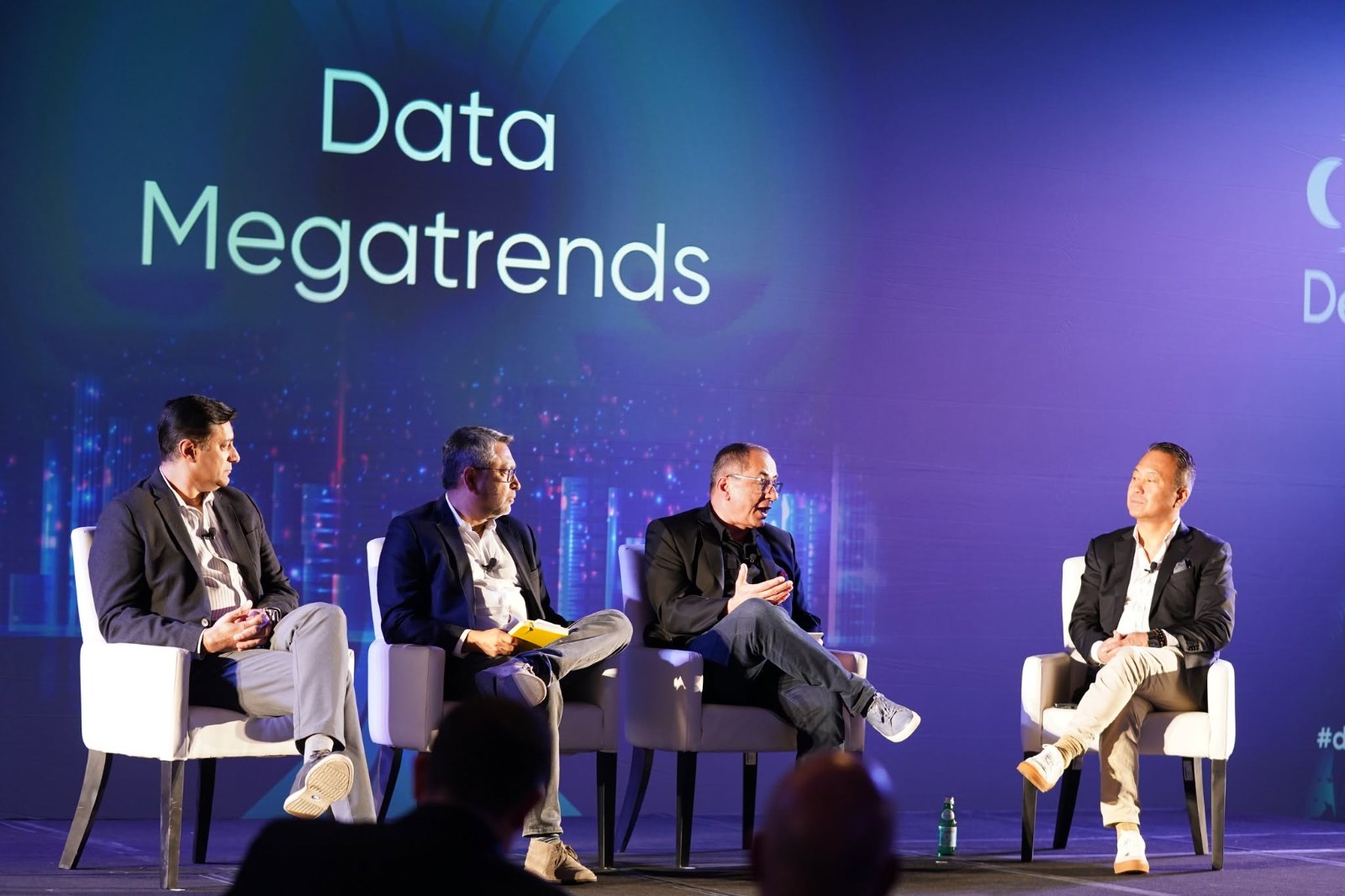 Data Megatrends panel on stage with four speakers